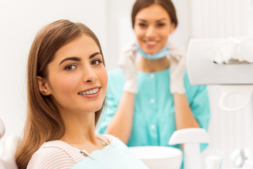 woman sitting in dental chair smiling