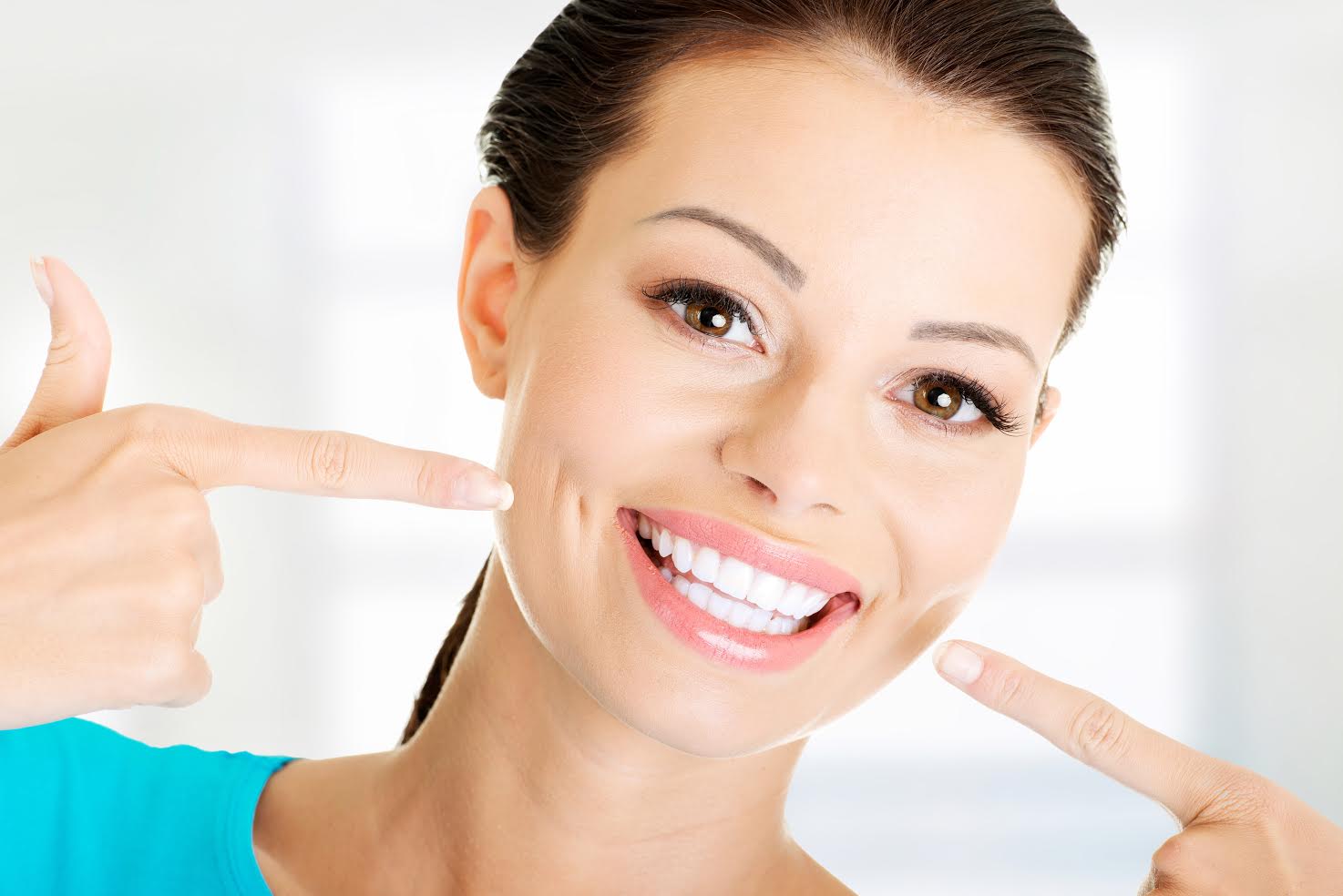 Woman smiling after her teeth whitening procedure